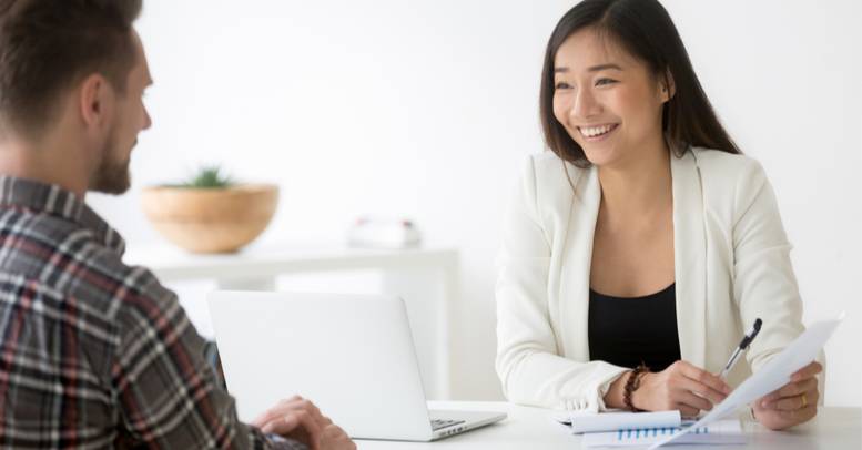 Young woman interviewing young man using the Omnia Profile, a personality test for hiring.